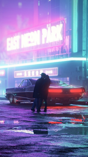 Couple kissing by a classic car in East Neon Park