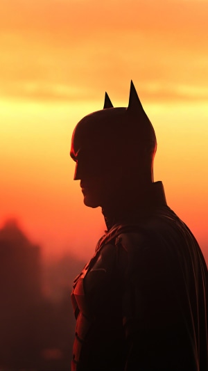 The Batman in front of an orange sky