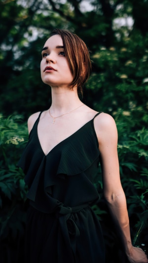 Woman in black dress with necklace