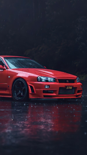 Red Nissan Skyline GT-R R34 in the rain