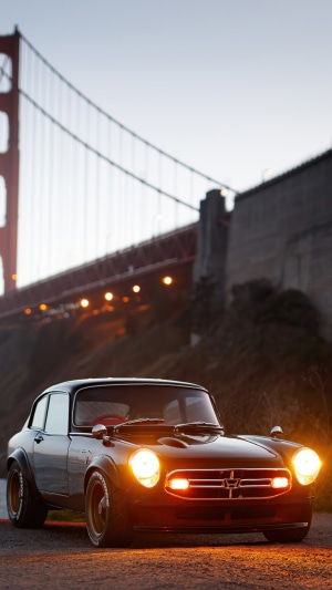 Black Honda S800 parked near Golden Gate Bridge