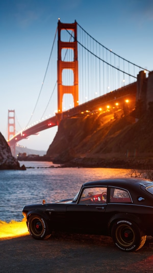 Black Honda S800 classic car by Golden Gate Bridge