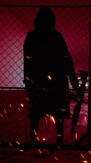 Silhouette of a person holding a rifle
