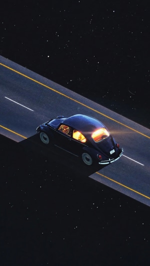 Artwork of a Volkswagen Beetle on a road at night