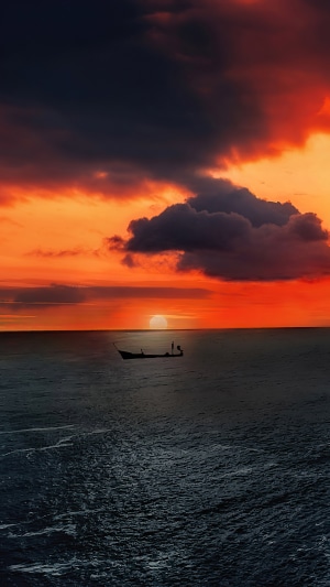Boat on the ocean at sunset 4K