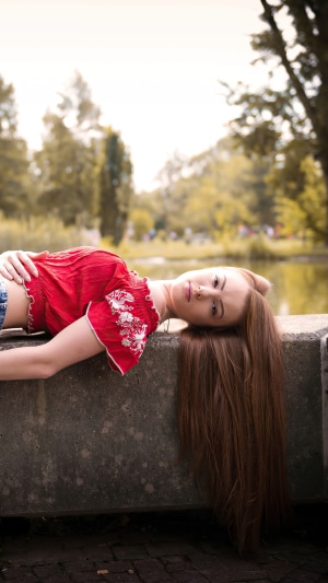 Girl with long brown hair lying down