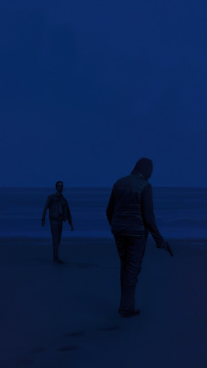 Two men on a beach at night, one holding a gun