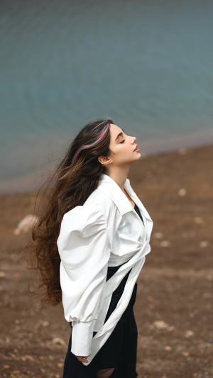 Girl with long hair by the water