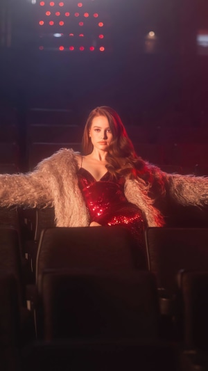 Madelaine Petsch in a red sequin dress and fur coat