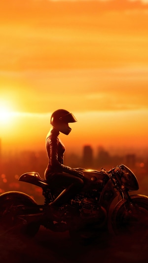 Catwoman from The Batman on a motorcycle at sunset