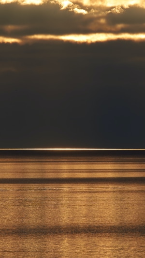 Sunset over the ocean with golden light