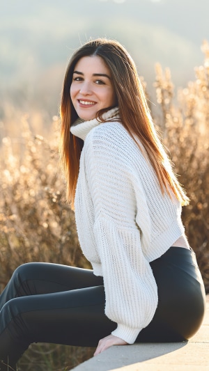 Girl in white sweater and black pants