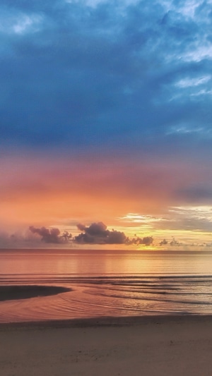 Sunrise over the ocean with colorful clouds