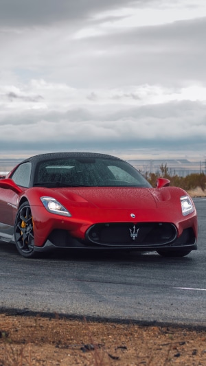 Red Maserati MC20 on a wet road