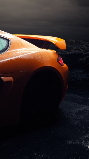 Orange Porsche Cayman with Spoiler in Rain