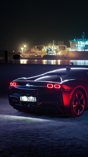 Ferrari SF90 Stradale parked by a harbor at night