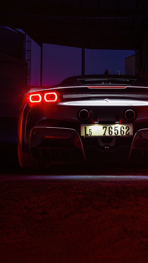 Ferrari SF90 Stradale rear view with illuminated taillights
