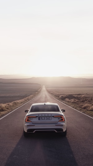 Volvo S60 sedan on a road at sunset