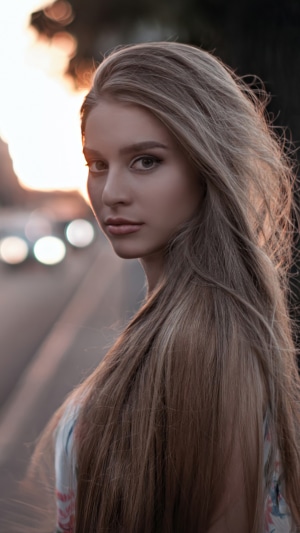 Blonde girl with long hair at sunset