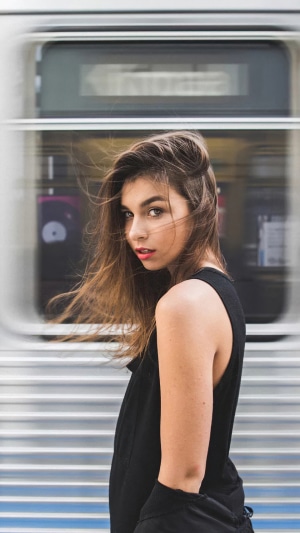 Brunette model in black tank top near subway