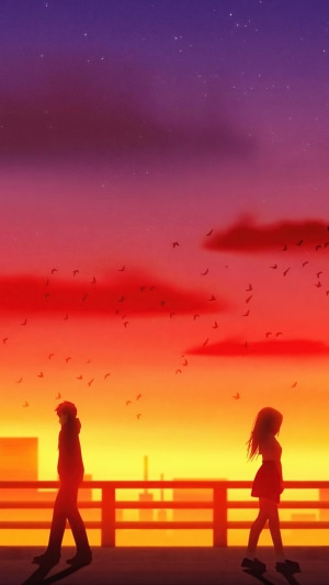 Couple walking away from each other at sunset