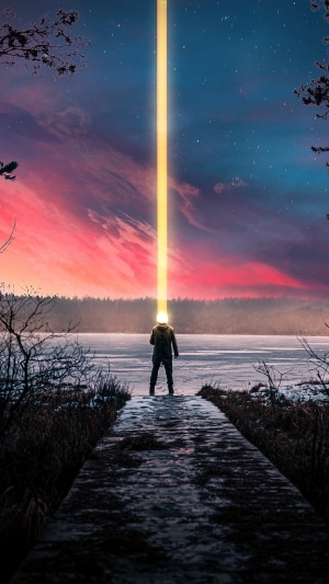 Person with light beam from head on pier
