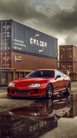 Red Toyota Supra with Shipping Containers
