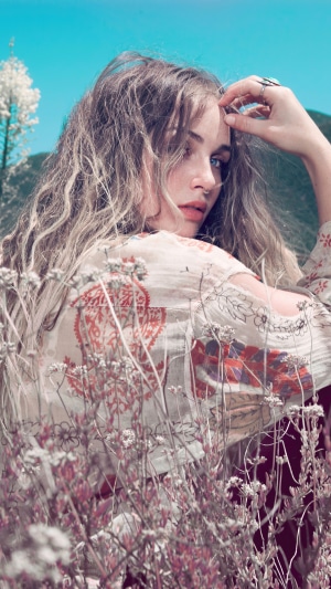 Zella Day in a field with flowers