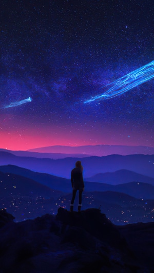 Person watching shooting stars over mountains