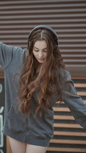 Girl with headphones wearing a hoodie
