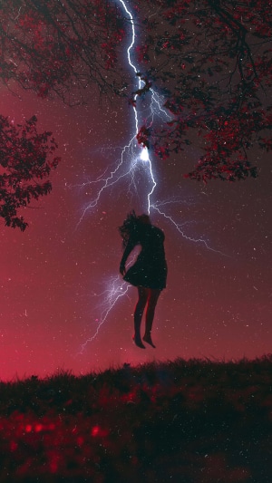 Lightning striking a person under a tree