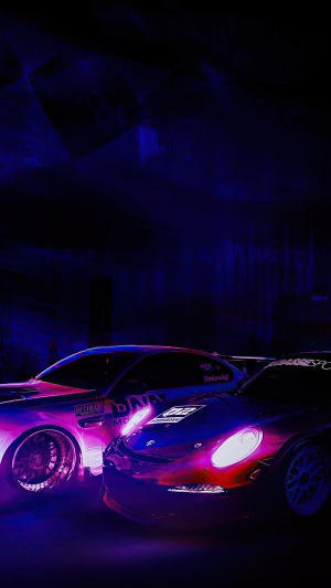Two sports cars illuminated by neon lights