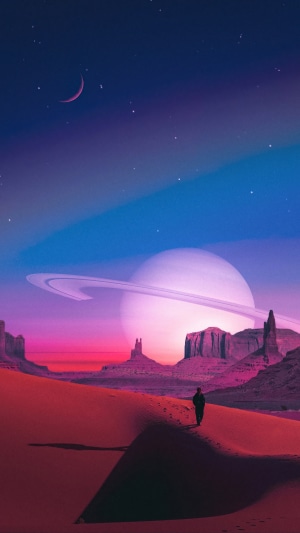 Man walking on desert planet with Saturn-like planet in sky