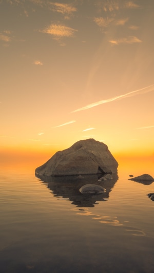 Rock in the ocean at sunset 4K