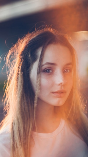Young woman with blonde hair in sunlight