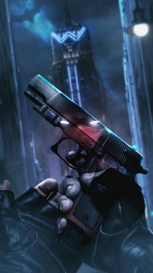 Red Hood holding a gun in a city at night
