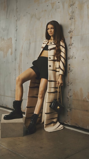 Zendaya in a tiger-striped coat and black shorts