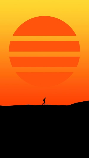 Silhouette of a person walking against a large sun