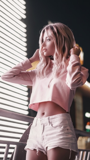 Woman in pink crop top and denim shorts