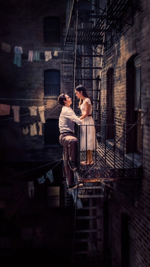 Couple on a fire escape in a city