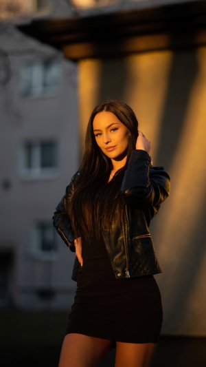 Model in black dress and leather jacket