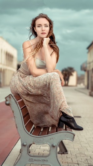 Woman sitting on a bench outdoors