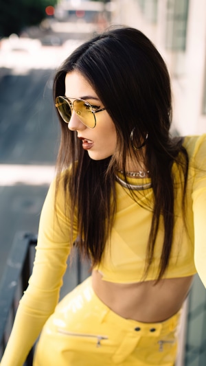 Victoria Justice in yellow outfit with sunglasses