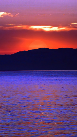 Sunset over mountains and water 4K