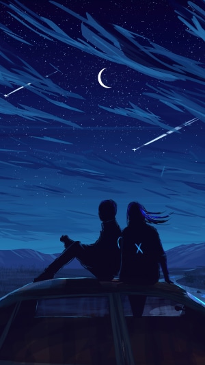 Couple watching shooting stars under a crescent moon
