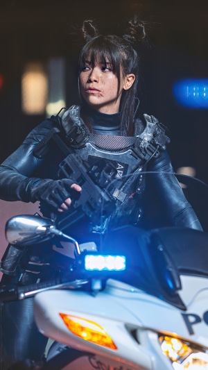 Sci-fi police officer with gun on motorcycle