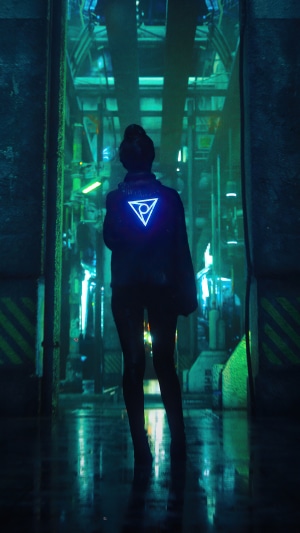 Woman with glowing triangle symbol on jacket in futuristic hallway