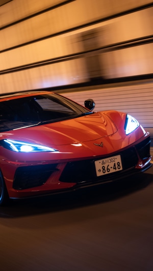 Red Chevrolet Corvette Stingray C8 driving in tunnel