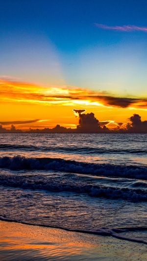 Sunset over the ocean with colorful clouds