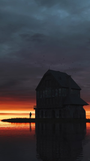 Silhouette of a person by a house at sunset
